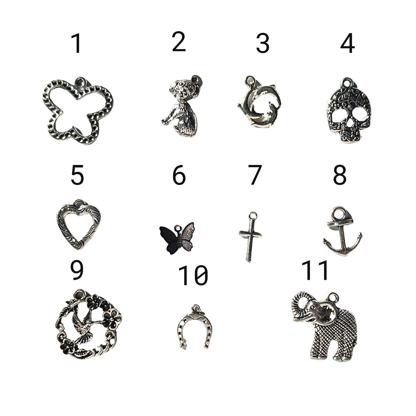silver colored charms 1- butterfly 2- dog 3- 3 dolphins in a circle 4- skull 5- heart 6- small 3D butterfly 7- small cross 8- anchor 9- hummingbird with wreath 10- horseshoe 11-elephant