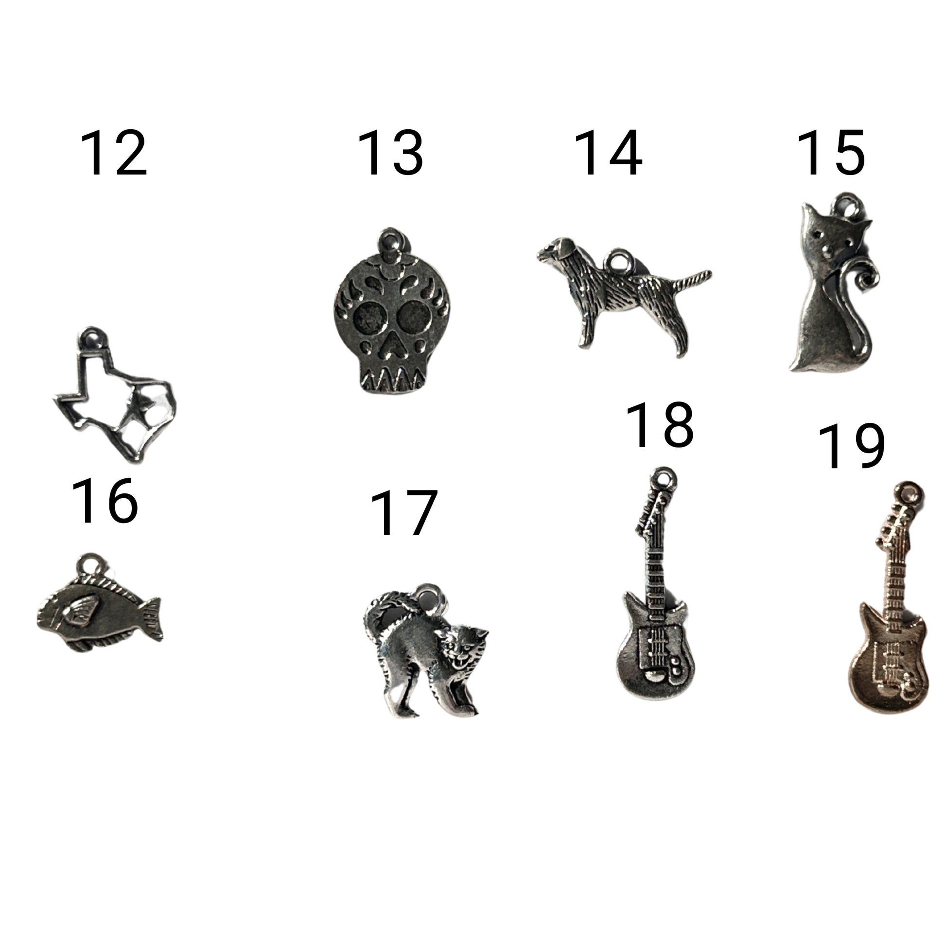 silver colored charms in order of 12- texas shape 13- skull 14- standing dog 15- sitting cat 16- fish 17- scaredy cat 19- silver guitar 19-gold guitar