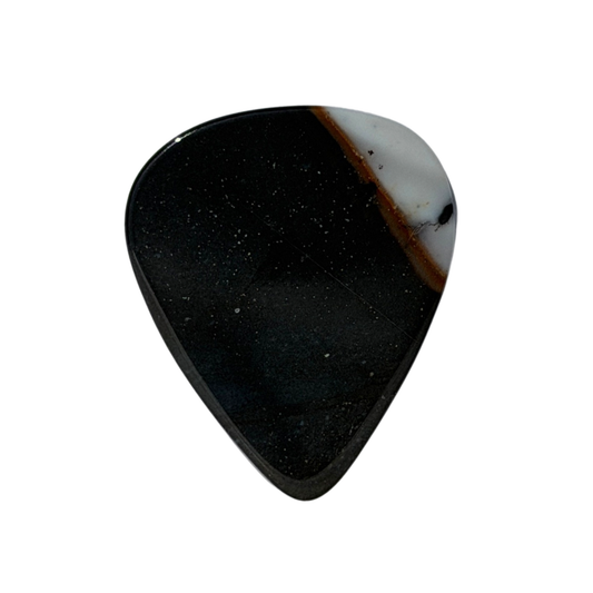 A standard stone guitar pick with a polished black surface speckled with tiny white flecks, featuring a natural white and brown stone inlay along the upper right edge, shown on a solid white background.